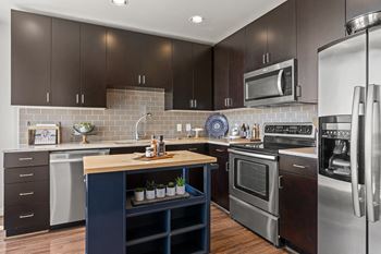 a kitchen with stainless steel appliances and a wooden counter top